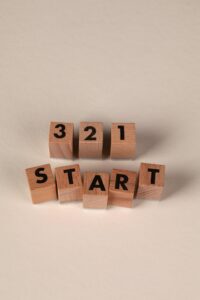 Wooden blocks arranged to spell out 3 2 1 Start on a neutral background.